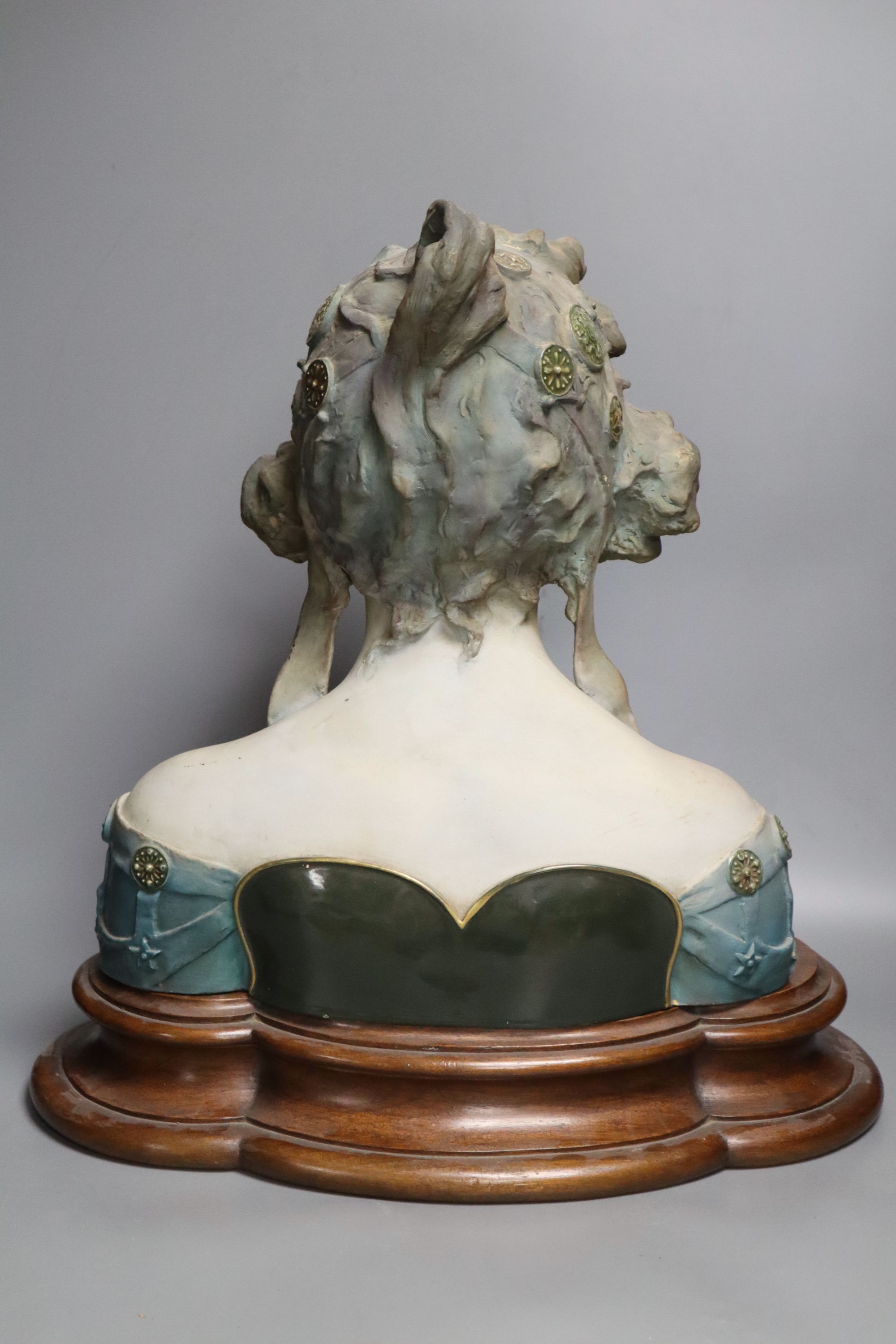 A pottery bust of a lady on a wooden stand, signed Jacobs, overall height 45cm